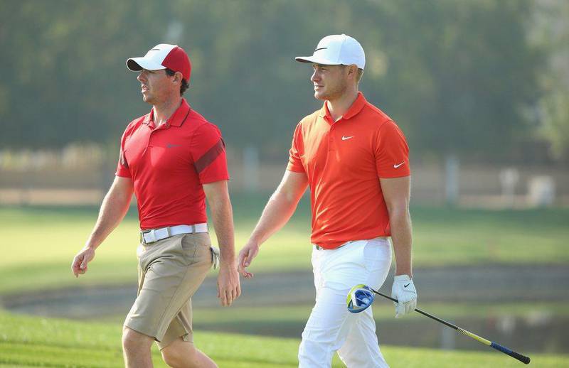 Rory McIlroy and Oliver Fisher walk together on the sixth hole during practice for the 2016 Omega Dubai Desert Classic on the Majlis Course at the Emirates Golf Club. Andrew Redington / Getty Images