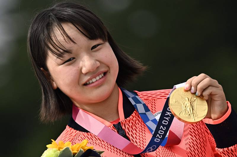 Japan's Momiji Nishiya poses with her gold medal during the podium ceremony of the skateboarding women's street final of the Tokyo 2020 Olympic Games at Ariake Sports Park.