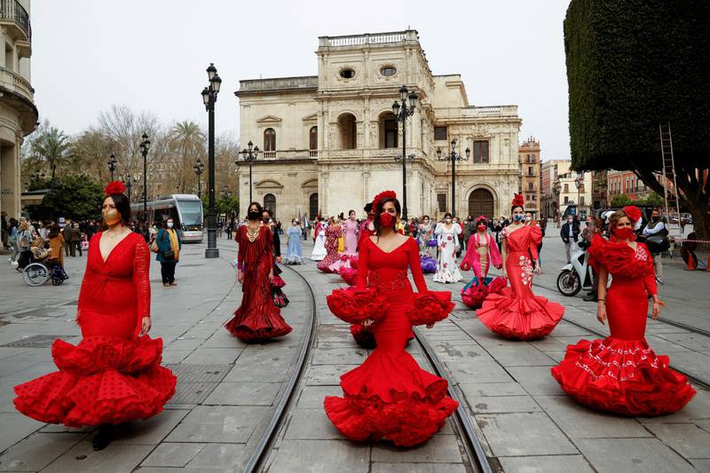 Women wearing flamenco dresses take part in a protest in Seville, Spain, against the crisis in the flamenco fashion sector caused by the coronavirus pandemic. Reuters