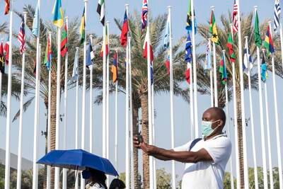 Flags of the participating nations adorn the main entrance near the Metro Station. Antonie Robertson / The National