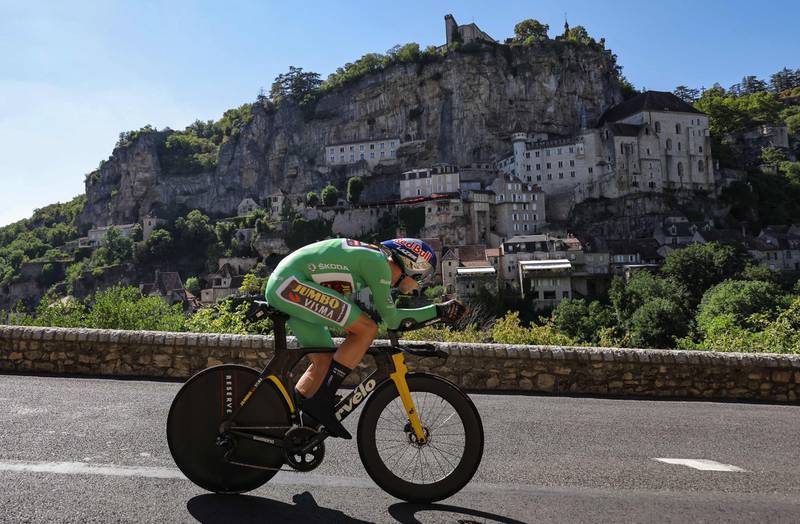 Jumbo-Visma team's Belgian rider Wout Van Aert wearing the sprinter's green jersey cycles past the town of Rocamadour. AFP