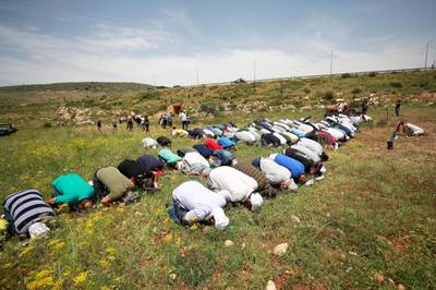 Palestinians pray during a protest marking the 72nd anniversary of Nakba in the village of Al Sawiya near Nablus. Reuters