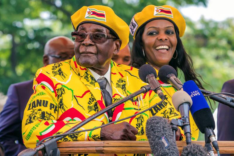 (FILES) This file photo taken on November 8, 2017 shows 
Zimbabwe's President Robert Mugabe (L) addressing party members and supporters gathered at his party headquarters to show support to Grace Mugabe (R) becoming the party's next Vice President after the dismissal of Emerson Mnangagwa.
Several tanks were seen moving near the Zimbabwean capital Harare on November 14, 2017 witnesses told AFP, a day after the army warned it could intervene over a purge of ruling party officials. / AFP PHOTO / Jekesai NJIKIZANA