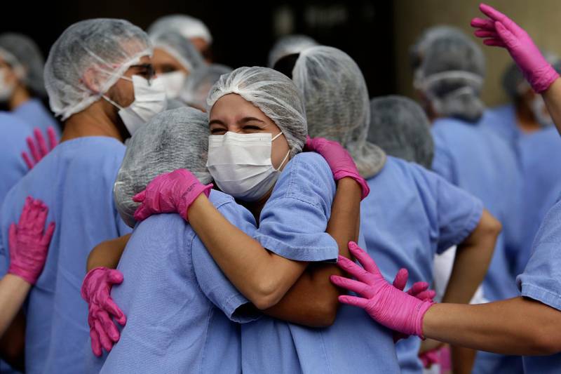 Medical workers celebrate as the last three patients are released from a field hospital at the National Stadium Mane Garrincha, after recuperating from Covid-19, in Brasilia, Brazil, on October 15, 2020. AP Photo