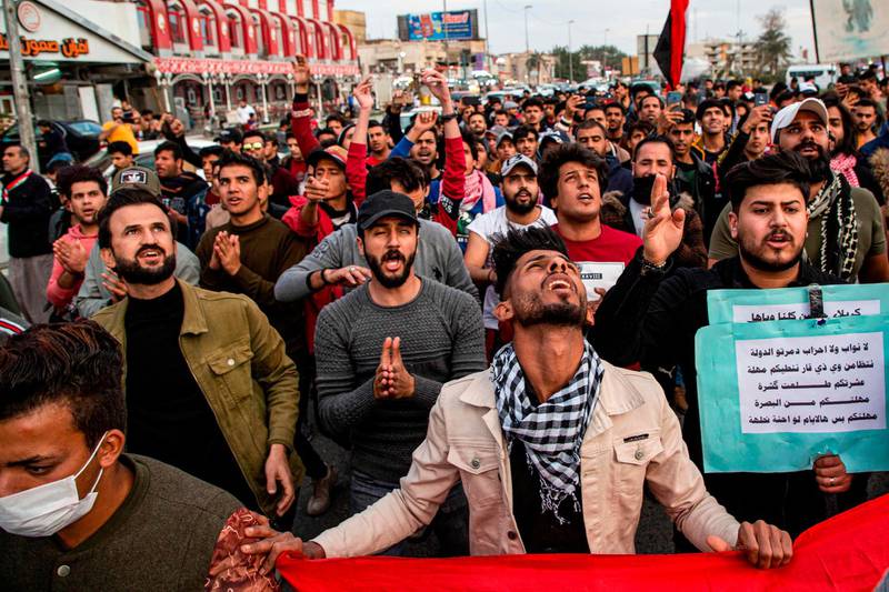 Protesters chant slogans as they march during an anti-government demonstration, also calling for freedom of the press, in the southern Iraqi city of Basra.  AFP