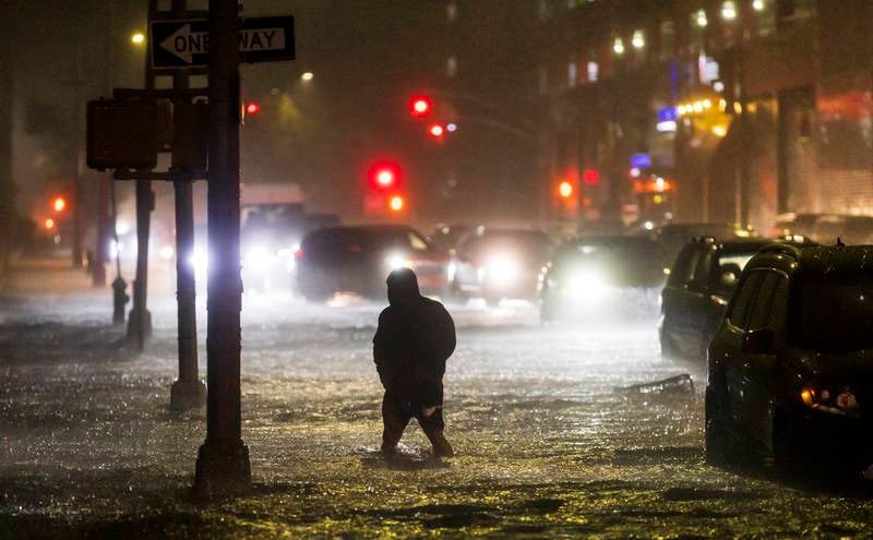 A man navigates a street flooded by heavy rain as remnants of Hurricane Ida hit the area in the Queens borough of New York, New York. EPA