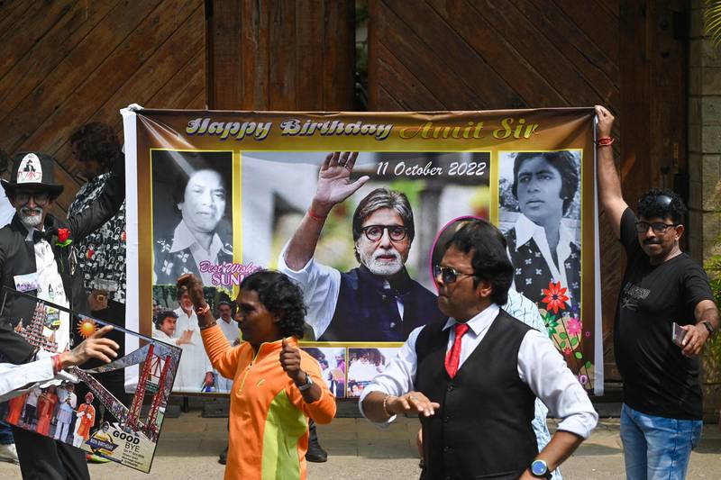 Fans of Bollywood actor Amitabh Bachchan dance outside his house in Mumbai to celebrate his 80th birthday. All photos: AFP