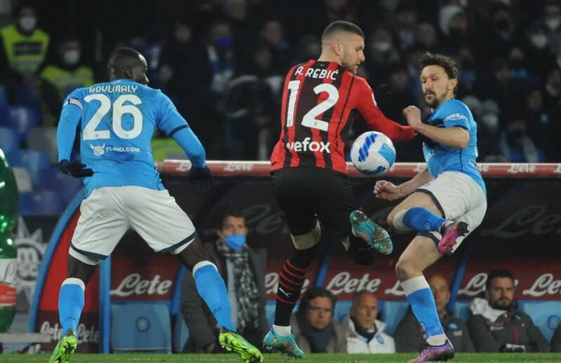 Napoli defenders Kalidou Koulibaly and Mario Rui challenge Milan forward Ante Rebic. EPA