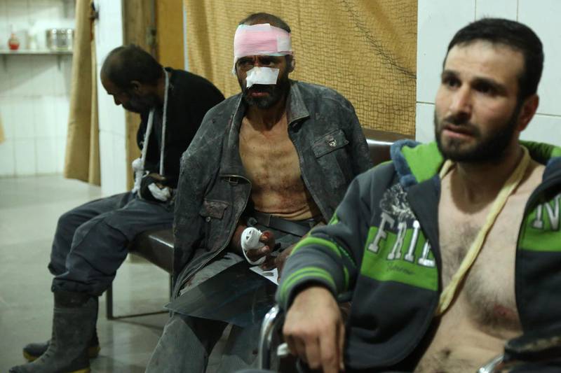Wounded Syrians wait to receive treatment at a make-shift hospital following Syrian government bombardments on the besieged rebel-held town of al-Ashaari in the eastern Ghouta region on the outskirts of the capital Damascus on March 3, 2018. Ammar Suleiman / AFP