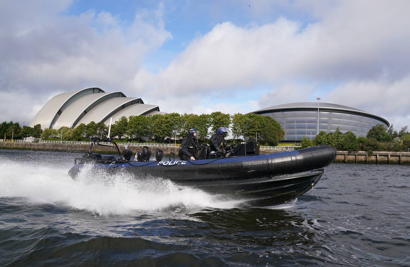 A Ministry of Defence police marine unit takes part in a training session next to the Armadillo and the Hydro at the Scottish Event Campus, the venue for the Cop26 summit in Glasgow. PA
