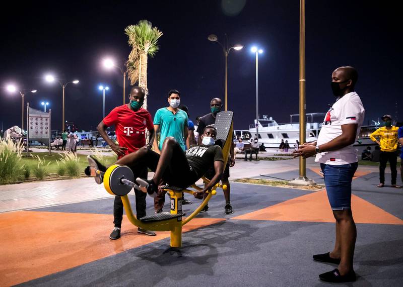 DUBAI, UNITED ARAB EMIRATES. 2 JUNE 2020. Men exercising in a park by Dubai Creek in Baniyas, Deira.(Photo: Reem Mohammed/The National)Reporter:Section: