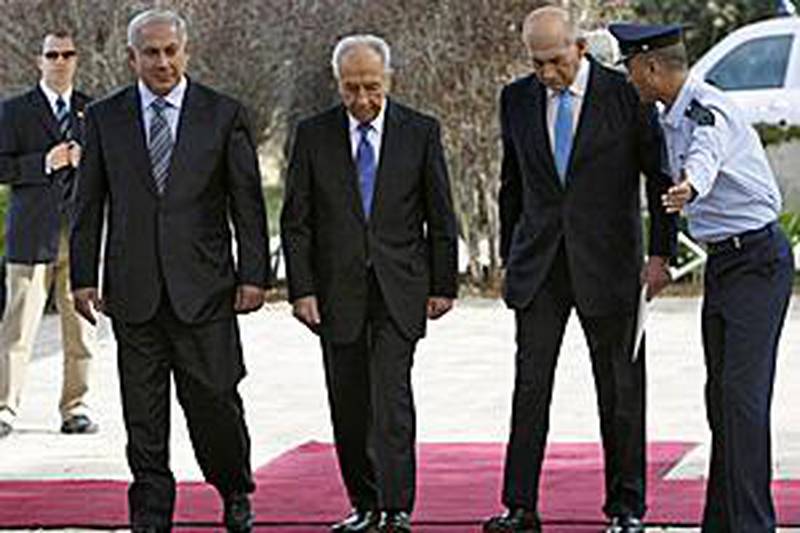 The new Israeli prime minister Benjamin Netanyahu, left, Shimon Peres, the president and the outgoing prime minister Ehud Olmert enter Mr Peres' residence in Jerusalem yesterday.