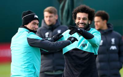 Liverpool's Takumi Minamino, left, and Mohamed Salah during a training session at Melwood training ground on Monday. PA