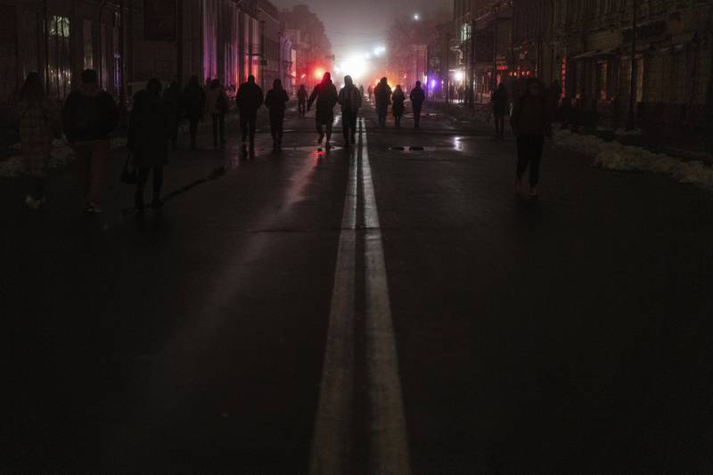 People walking in the dark city centre of Kyiv which lost electrical power after Russian rocket attacks. AP 