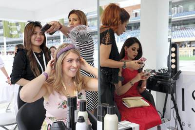 DUBAI , UNITED ARAB EMIRATES , MARCH 30  – 2018 :-  Left to Right – Christina and Mona at the sisters stand doing makeup  before the start of Dubai World Cup held at Meydan Racecourse in Dubai. ( Pawan Singh / The National ) For News/Sports/Instagram/Big Picture. Story by Amith/Rupert