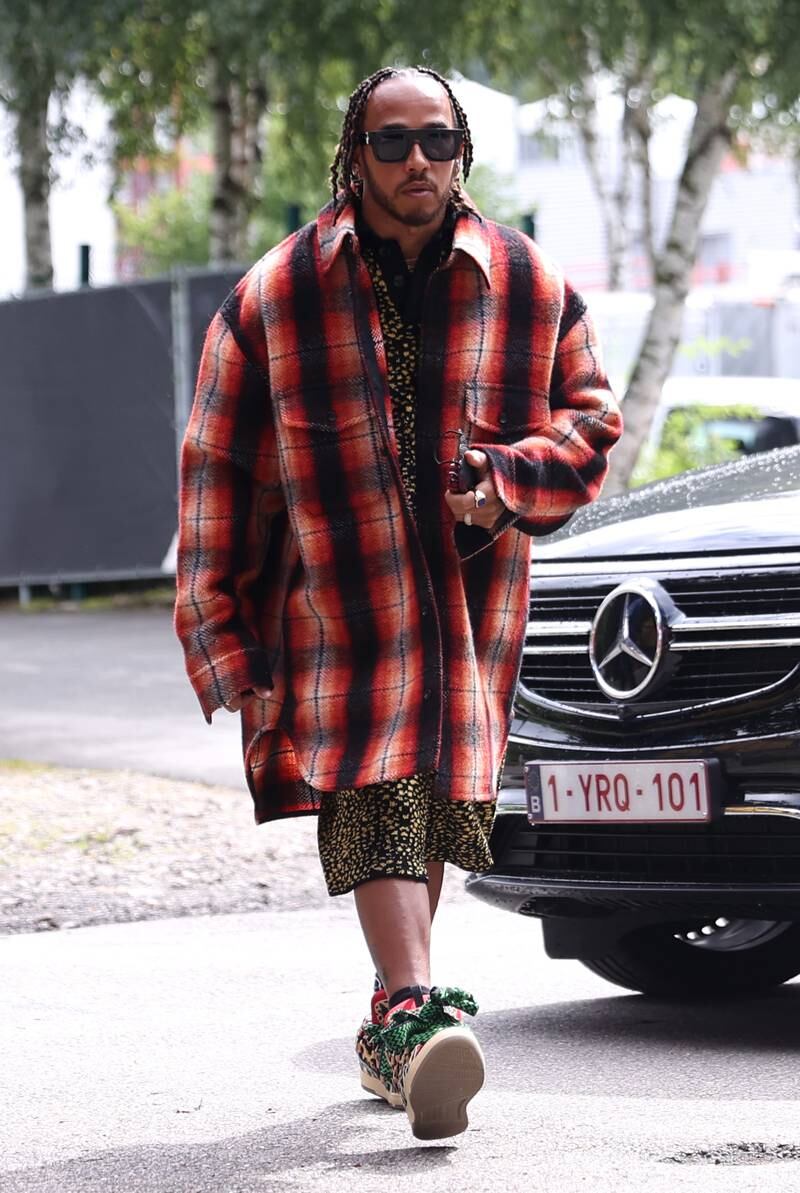 Lewis Hamilton, in an oversized tartan Lanvin shirt, walks in the paddock ahead of the Belgian Grand Prix on August 26, 2021. Getty Images