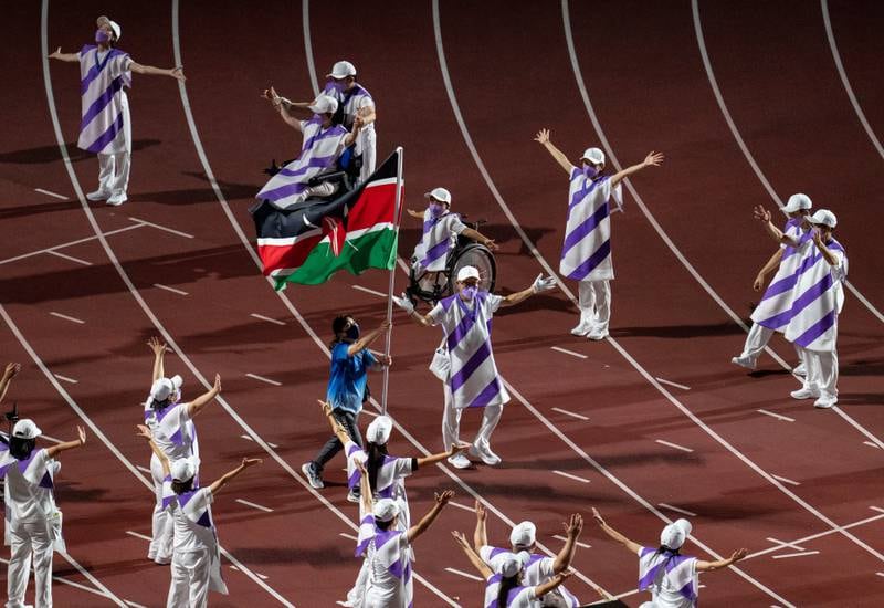 The national flag of Kenya being carried by a Paralympic volunteer. EPA