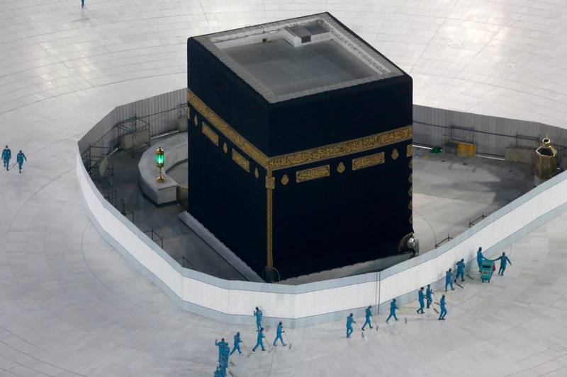 Workers disinfect the ground around the Kaaba, the cubic building at the Grand Mosque, in the city of Makkah. AP