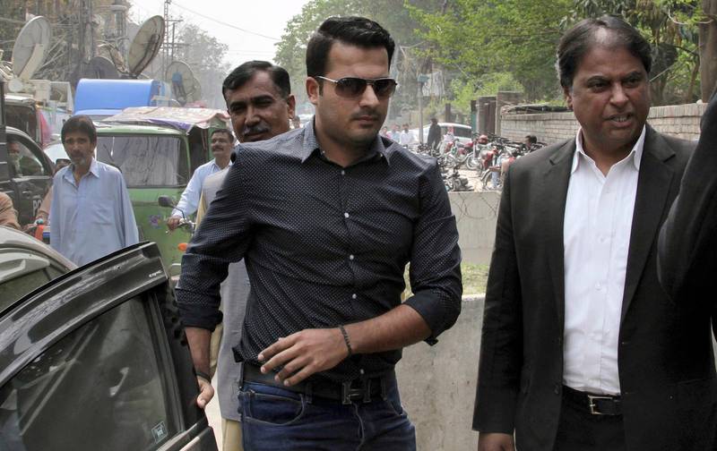 FILE - In this Tuesday, March 21, 2017 file photo, Pakistani provisionally suspended cricketer Sharjeel Khan, center, arrives at the office of Federal Investigation Authority for recording his statements, in Lahore, Pakistan. Pakistan Cricket Board's anti-corruption tribunal banned test cricketer Khan for five years for spot-fixing on Wednesday, Aug. 30, 2017.
 (AP Photo/K.M. Chaudary, File)