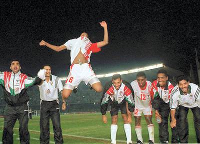 United Arab Emirates's Ismail Ismail leaps up in the air as he celebrates with his team their victory over Iraq after their Asian Cup first quarter final 15 December Abu Dhabi. The UAE beat Iraq 1-0  with a "sudden death" goal from a 35 yards free kick by Abdel Hussain in the 14th minute of extra time. (Photo by JORGE FERRARI / AFP)