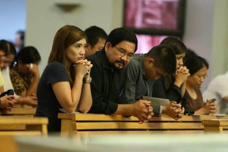 DUBAI , UNITED ARAB EMIRATES Ð Sep 8 : Left to Right - Lourdes , Pablo Varona , Louis and Lisa family members of Lorna Lim Varona during the eulogy mass held at St . Mary Õ s Church in Dubai. ( Pawan Singh / The National ) For  News. Story by Ramona
