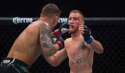 Dustin Poirier throws a punch against Justin Gaethje. AFP