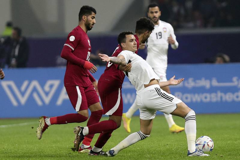 UAE's Caio Canedo, centre, fights for the ball during the Arabian Gulf Cup match against Qatar at the Al Minaa Olympic Stadium in Basra, Iraq, on Friday, January 13, 2023. AP