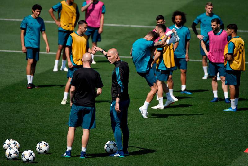 Real Madrid manager Zinedine Zidane talks to a coach during training ahead of the Uefa Champions League final. Gabriel Bouys / AFP