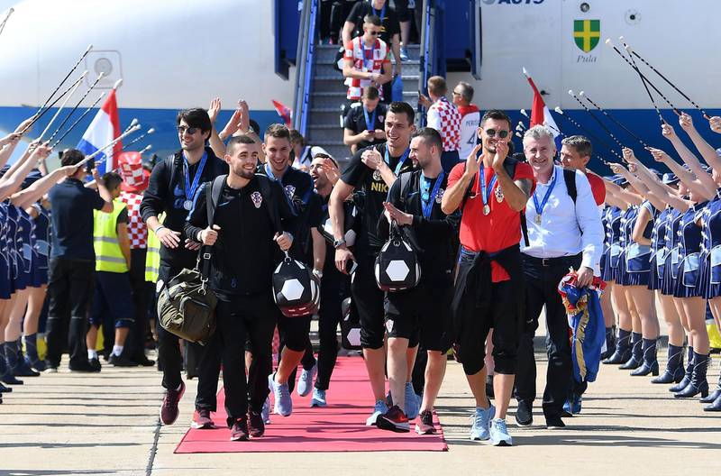 Croatian national football team members step out at the Zagreb international airport. Attila Kisbenedek / AFP