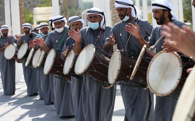 Emirati traditional musicians greet visitors upon arrival. EPA