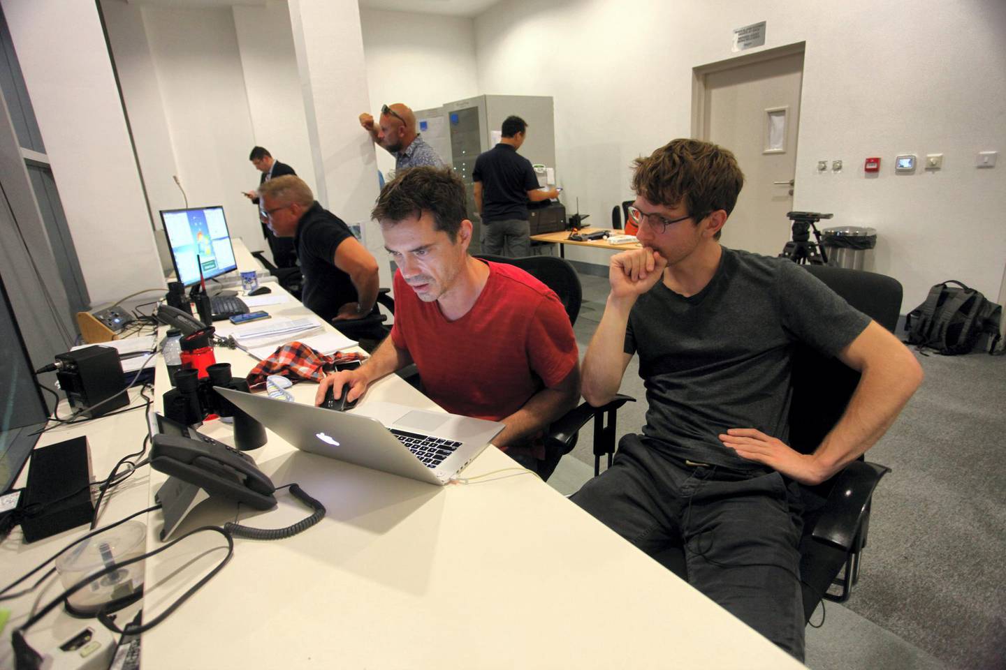 Head choreographer Peter Kopik (red shirt) in the control room above The Dubai Fountain, working on a new performance on WET’s proprietary programming software, Courtesy WET