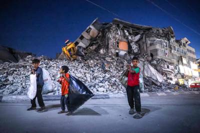 Palestinian boys walk past the destroyed Al Shuruq tower in Gaza City's Al Rimal neighbourhood. AFP