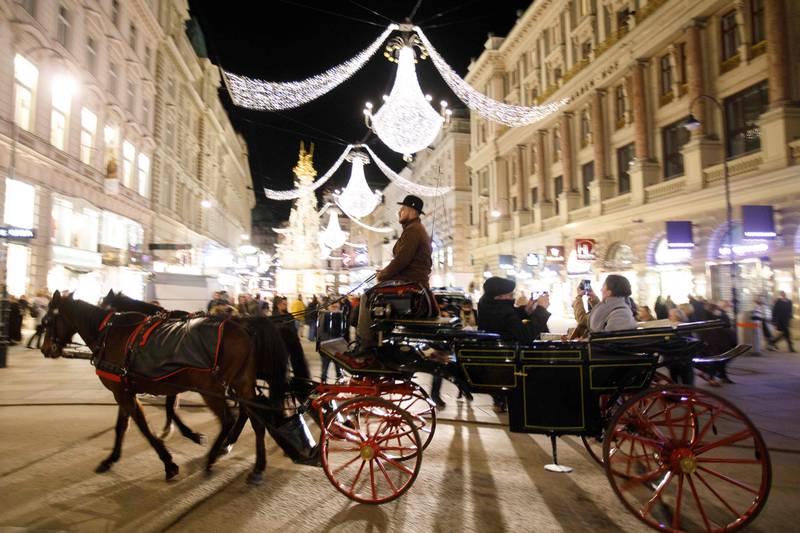 A carriage drives through an illuminated street in the city centre of Vienna, Austria. AFP