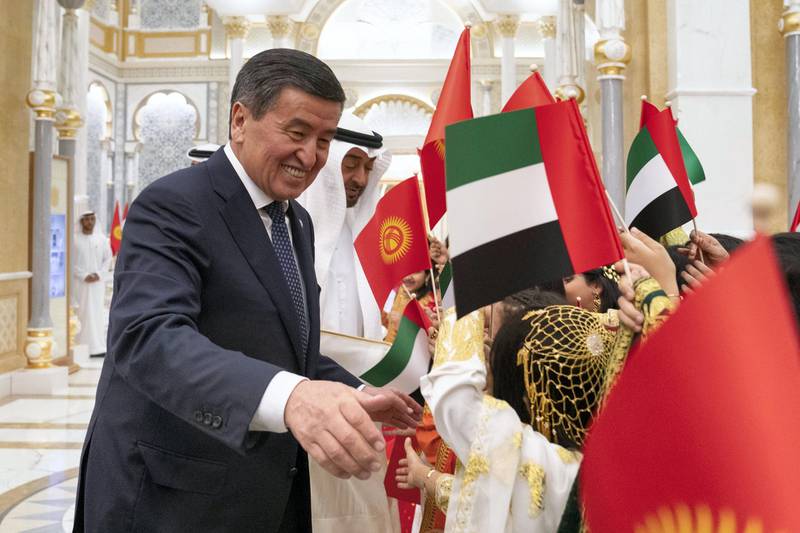 ABU DHABI, UNITED ARAB EMIRATES - December 12, 2019: HH Sheikh Mohamed bin Zayed Al Nahyan, Crown Prince of Abu Dhabi and Deputy Supreme Commander of the UAE Armed Forces (2nd L) and HE Sooronbay Sharipovich Jeenbekov, President of Kyrgyzstan (L), greets school children during an official visit reception, at Qasr Al Watan. 

( Ryan Carter for the Ministry of Presidential Affairs )
---