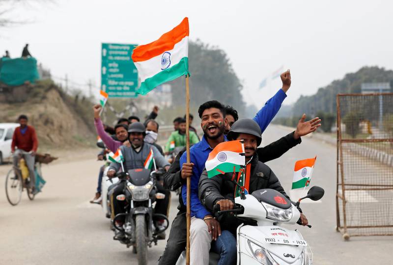 People ride motorbikes before the arrival of Indian Air Force pilot, who was captured by Pakistan on Wednesday, near Wagah border, on the outskirts of the northern city of Amritsar, India, March 1, 2019. Reuters