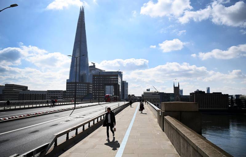 A pedestrian walks over a quiet London Bridge in London. EPA