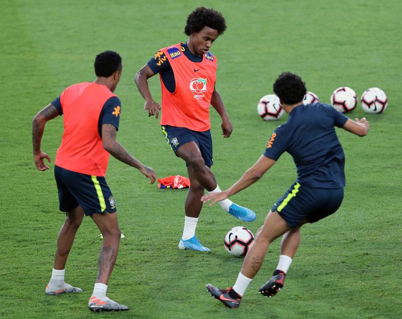 Brazil's William, centre, plays during training in Abu Dhabi. AP