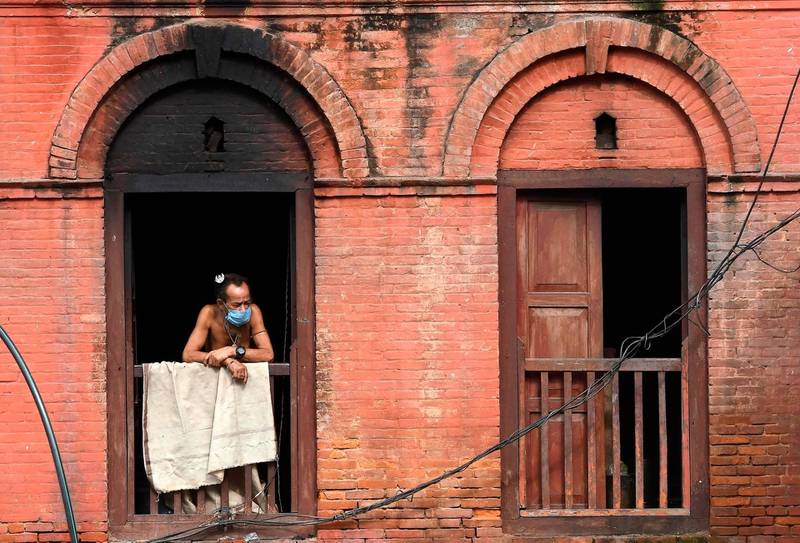 A Hindu Sadhu looks out from a window on at the premises of the Pashupatinath temple in Kathmandu. AFP