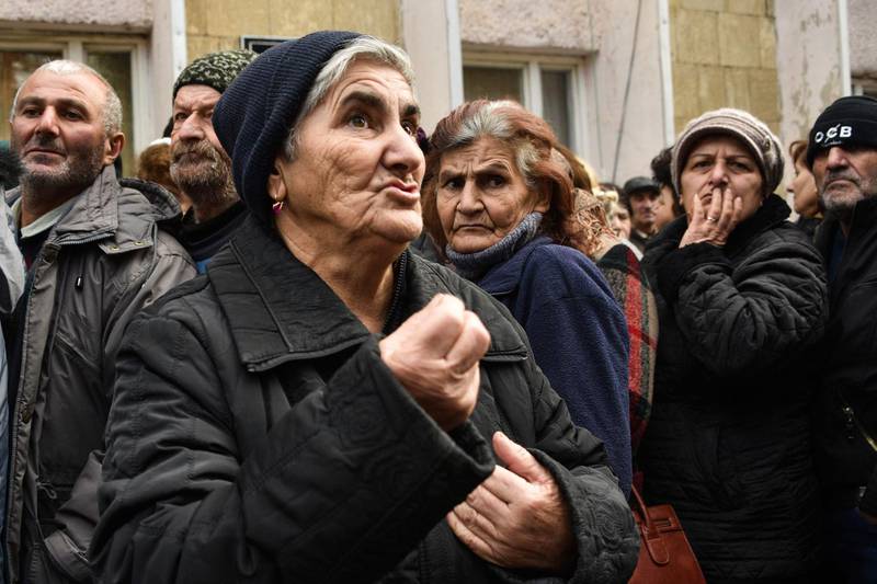 Elmira Grigoryan, 70, a refugee from the village of Vazgenashen which is under the control of Azerbaijan, queues to receive a food package in Stepanakert. AFP