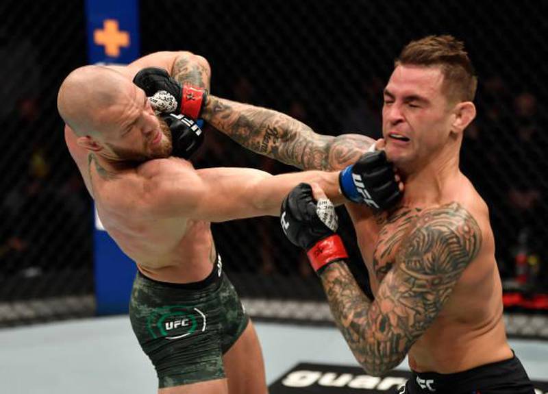ABU DHABI, UNITED ARAB EMIRATES - JANUARY 23: (L-R) Conor McGregor of Ireland punches Dustin Poirier in a lightweight fight during the UFC 257 event inside Etihad Arena on UFC Fight Island on January 23, 2021 in Abu Dhabi, United Arab Emirates. (Photo by Jeff Bottari/Zuffa LLC)