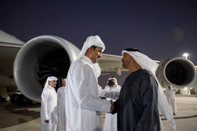 President Sheikh Mohamed greets Qatar's Emir Sheikh Tamim at the Presidential Airport in Abu Dhabi on November 9