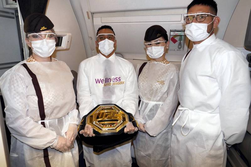 Etihad's Wellness Ambassador and Cabin Crew showcase the UFC Championship belt. Etihad Airways