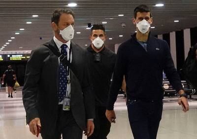 Novak Djokovic walks through departures at Melbourne Airport before boarding a flight to Dubai. Reuters