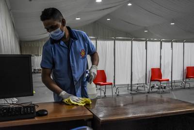 Beirut, Lebanon, 13 February, 2021. A janitor disinfects surfaces as a new vaccine center is set up at St George's hospital, on the eve of Lebanons Covid-19 vaccine roll-out. Lebanon is preparing to receive its first, Pfizer-Biontech Covid-19 vaccines.