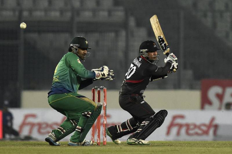 UAE cricketer Shaiman Anwar (R) plays a shot as the Pakistan wicketkeeper Sarfraz Ahmed (L) looks on during the Asia Cup T20 cricket tournament match between Pakistan and United Arab Emirates at the Sher-e-Bangla National Cricket Stadium in Dhaka on February 29, 2016. AFP PHOTO / MUNIR UZ ZAMAN