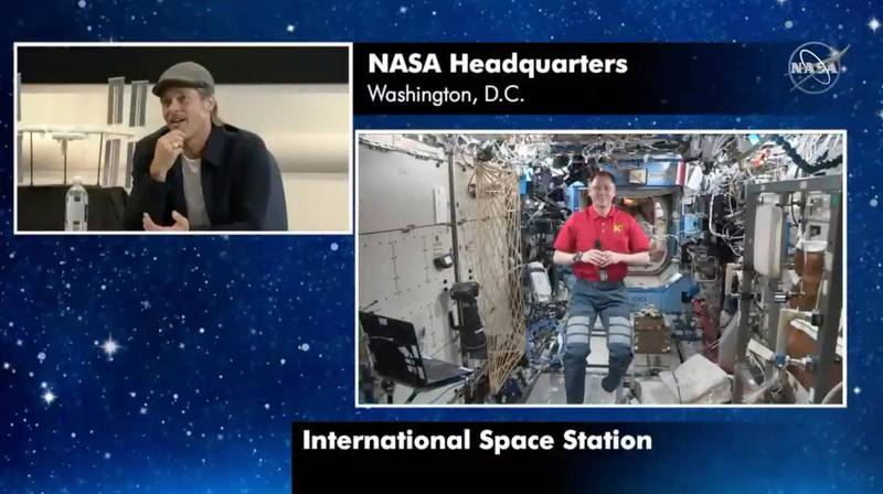 In this image taken from NASA video actor Brad Pitt, left, star of the new space movie â€œAd Astra,â€ speaks from NASA headquarters in Washington, to astronaut Nick Hague abroad the International Space Station, on Monday, Sept. 16, 2019. (NASA via AP)