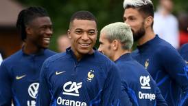 Kylian Mbappe smiles but not for the camera after refusing to take part in team photoshoot