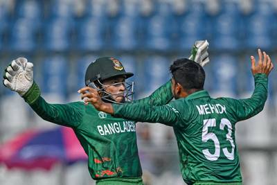 Bangladesh's Mehidy Hasan Miraz celebrates with his teammate Mushfiqur Rahim after taking the wicket of South Africa's Rassie van der Dussen. AFP