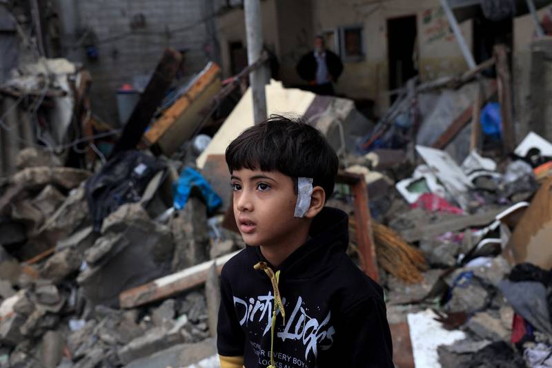 A Palestinian child sits on the rubble of a home destroyed in Israeli strikes in Rafah. AFP