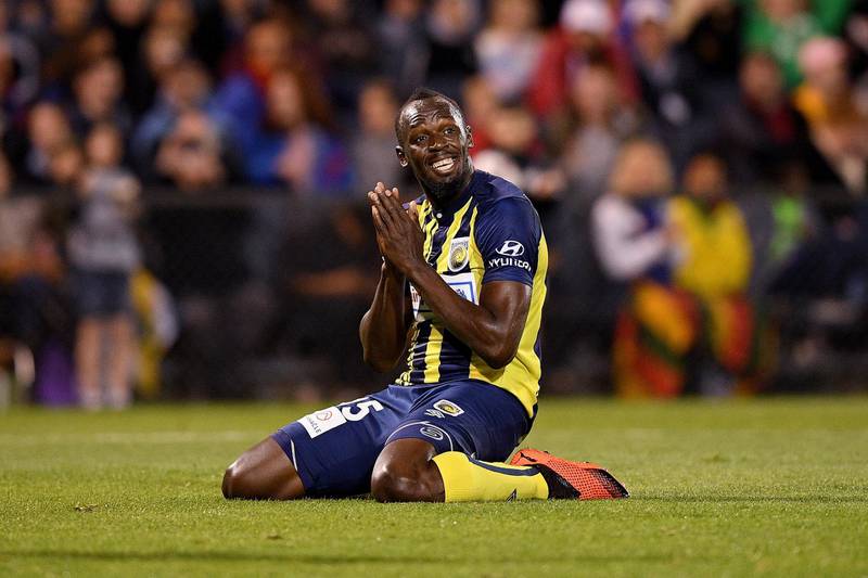 epa07087930 Usain Bolt of the Mariners reacts after missing a shot at goal during a Hyundai A-League trial match between the Central Coast Mariners and Macarthur South West United at Campbelltown Stadium in Sydney, Australia, 12 October 2018.  EPA/DAN HIMBRECHTS EDITORIAL USE ONLY AUSTRALIA AND NEW ZEALAND OUT
